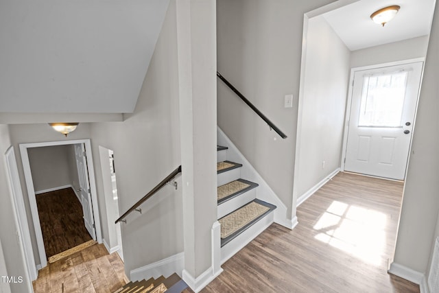 entryway with wood finished floors and baseboards