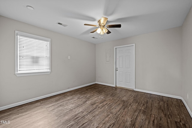 empty room with visible vents, ceiling fan, baseboards, and wood finished floors