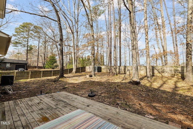 wooden terrace with a fenced backyard