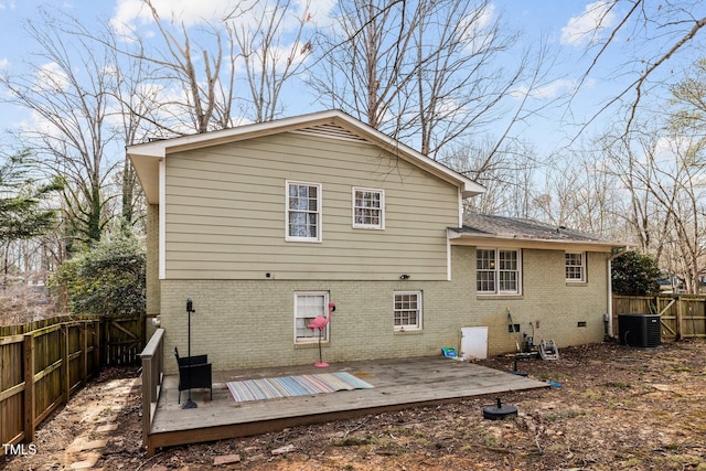 back of property with brick siding, crawl space, central AC unit, and a fenced backyard