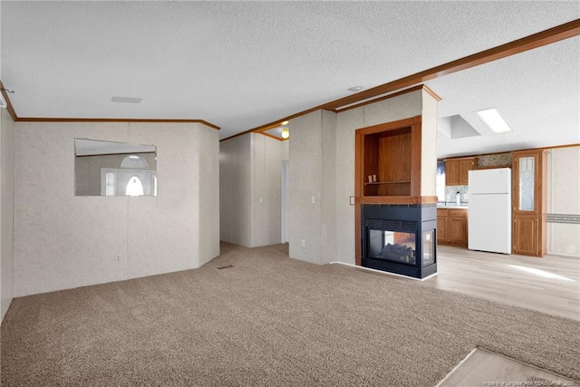 unfurnished living room featuring ornamental molding, a multi sided fireplace, a textured ceiling, and light colored carpet