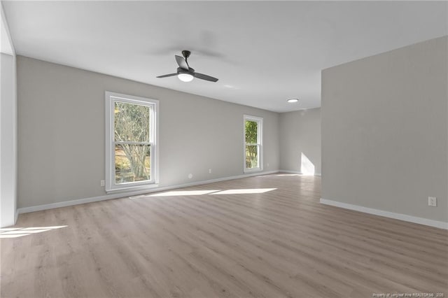 spare room featuring ceiling fan, plenty of natural light, and light hardwood / wood-style floors