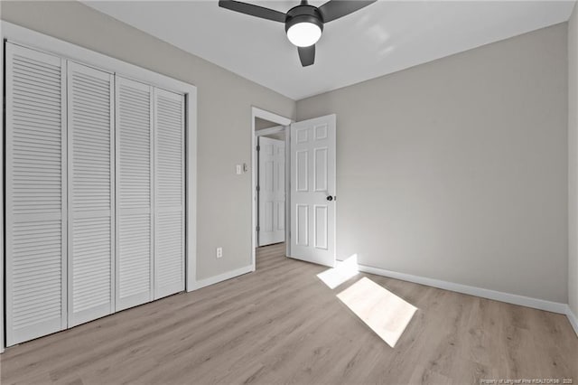 unfurnished bedroom featuring a closet, ceiling fan, and light hardwood / wood-style flooring