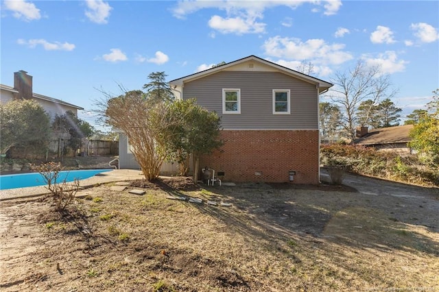 view of side of property with a fenced in pool