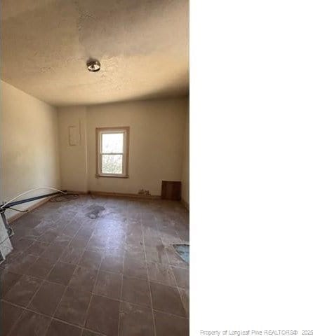 spare room featuring a textured ceiling