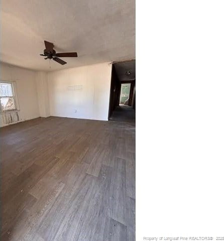 empty room featuring ceiling fan and dark hardwood / wood-style flooring