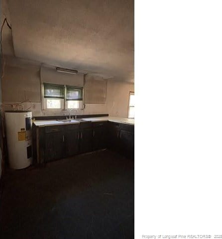 kitchen with sink, electric water heater, and dark brown cabinetry