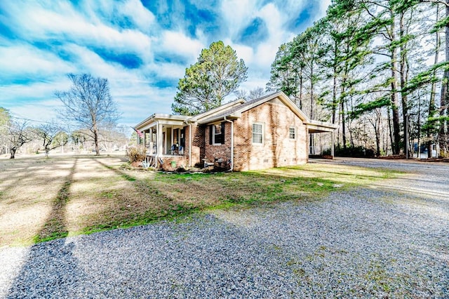 view of front of house featuring a carport and a porch