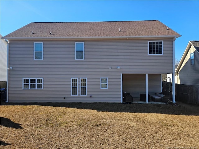 back of house featuring a yard