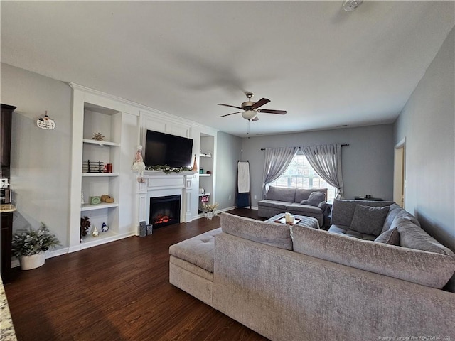 living room featuring ceiling fan, dark hardwood / wood-style floors, and built in features