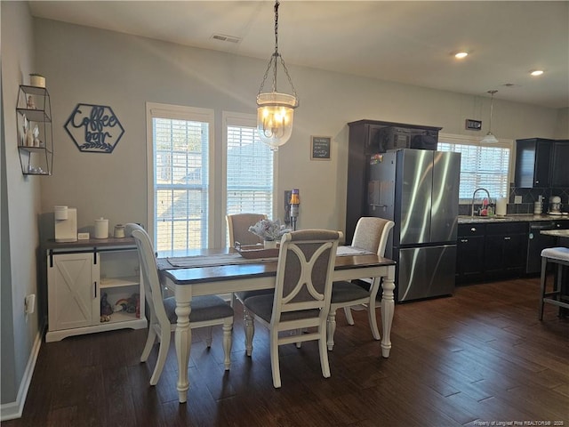 dining area with sink and dark wood-type flooring