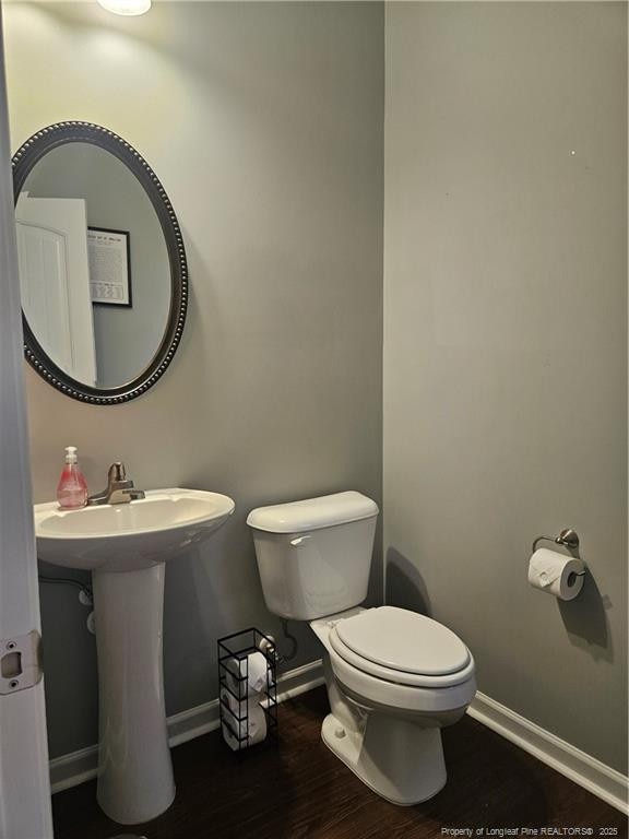 bathroom featuring toilet and hardwood / wood-style floors