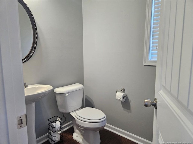 bathroom featuring sink, toilet, and hardwood / wood-style floors