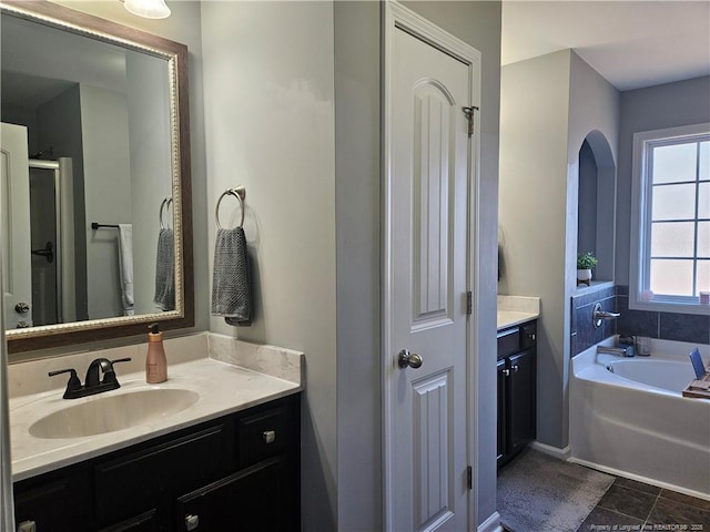 bathroom featuring separate shower and tub and vanity