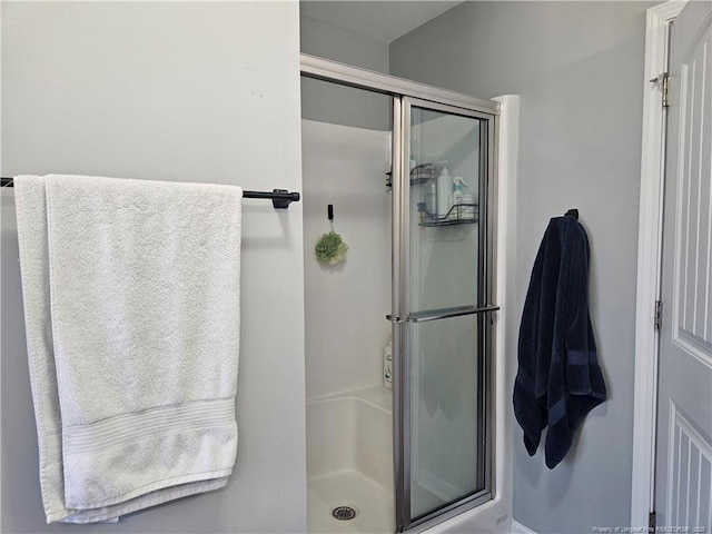 bathroom featuring a shower with shower door