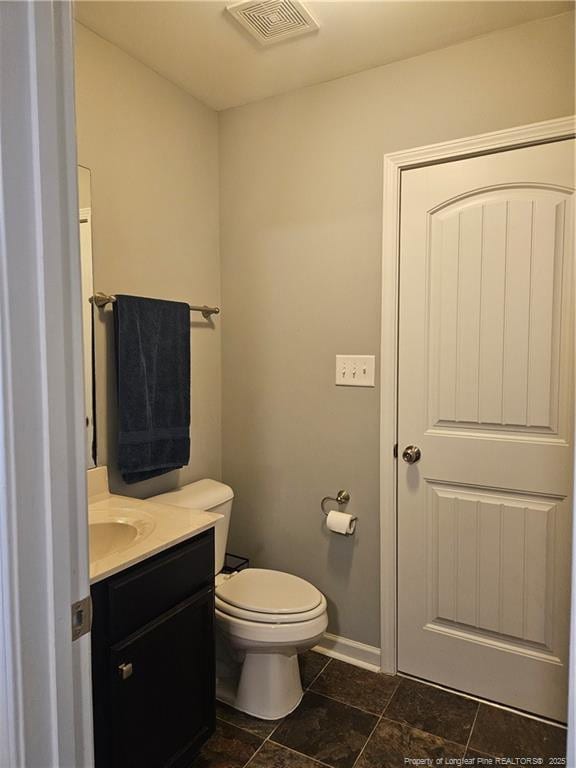 bathroom with toilet and vanity