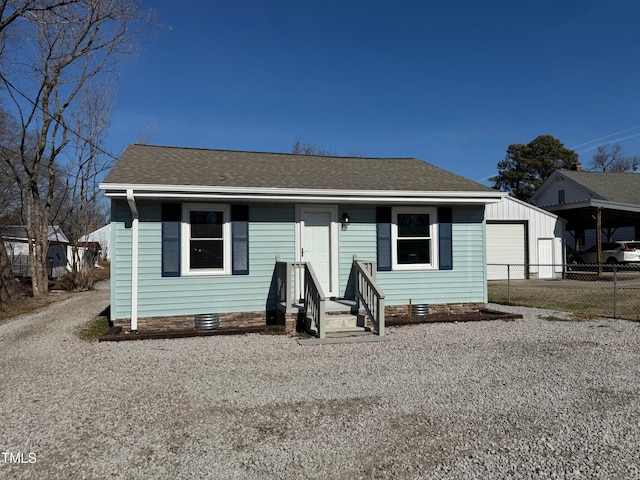 212 Craig Ave, Henderson, NC 27537 - bungalow-style home featuring gravel driveway, roof with shingles, crawl space, fence, and a garage