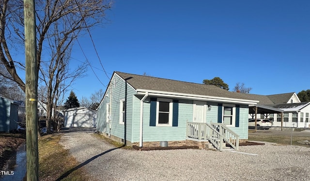 view of front of home with an outbuilding, driveway, and a detached garage