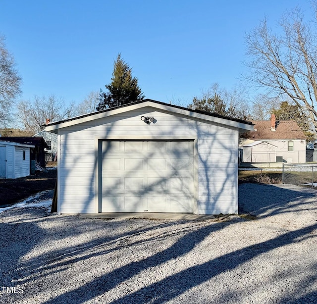 212 Craig Ave, Henderson, NC 27537 - detached garage featuring driveway and fence