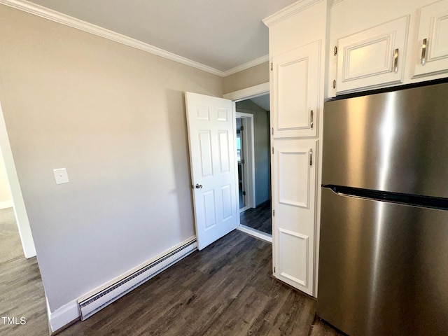 212 Craig Ave, Henderson, NC 27537 - kitchen with a baseboard radiator, white cabinetry, freestanding refrigerator, dark wood-style floors, and crown molding