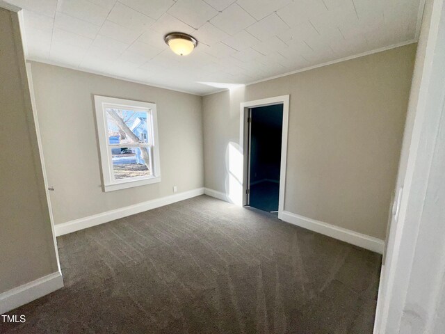 212 Craig Ave, Henderson, NC 27537 - unfurnished bedroom with baseboards and dark carpet