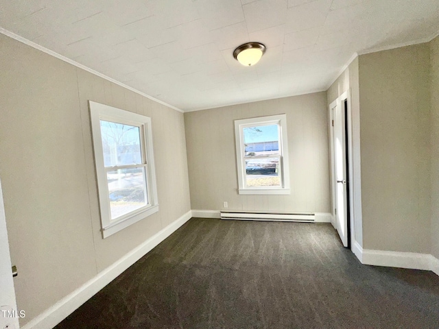 212 Craig Ave, Henderson, NC 27537 - spare room with baseboards, ornamental molding, baseboard heating, and dark colored carpet