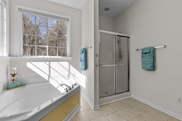 full bath with tile patterned flooring, a shower stall, baseboards, and a bath