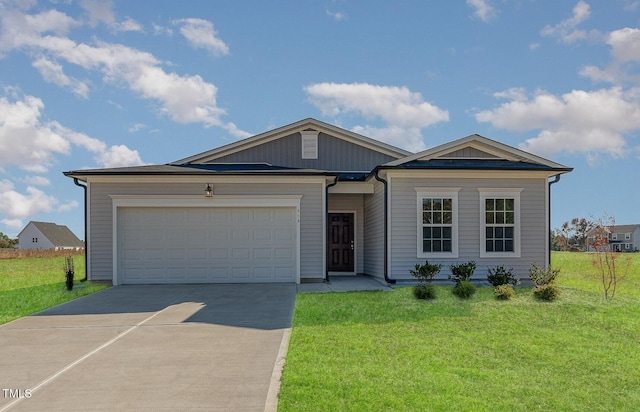 view of front of house featuring an attached garage, driveway, and a front yard