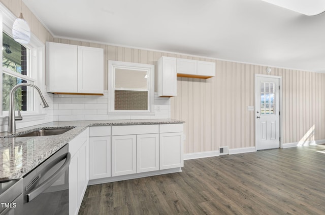 kitchen with dishwasher, sink, and white cabinets