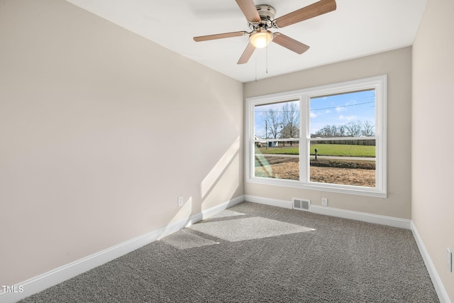 carpeted spare room with ceiling fan