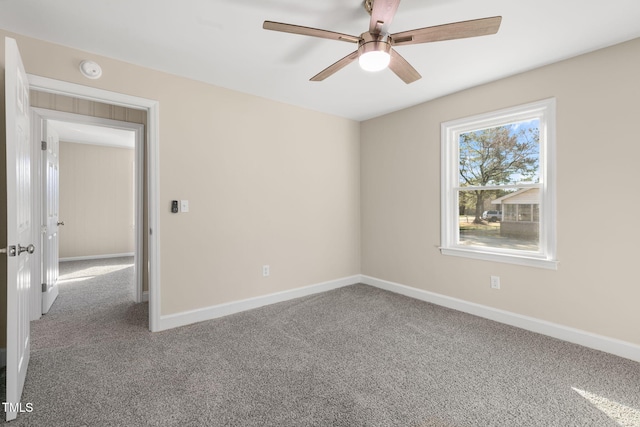 carpeted spare room with ceiling fan