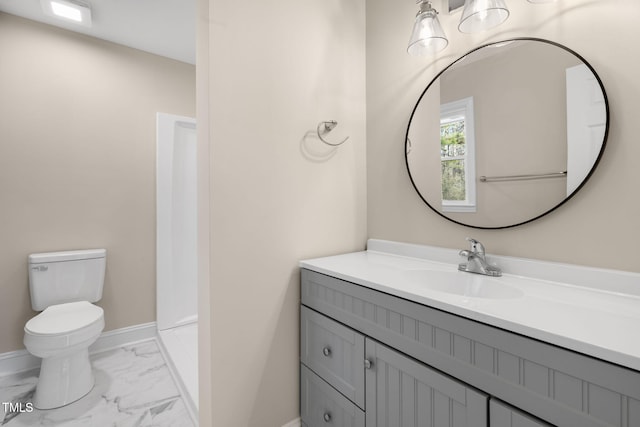 bathroom featuring a shower, toilet, and vanity