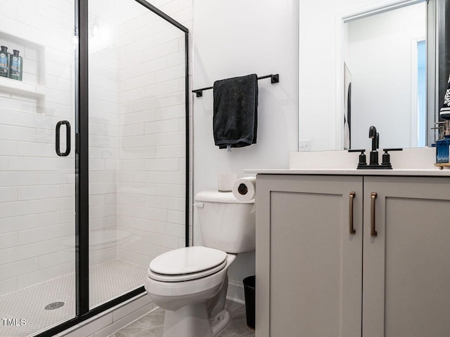 full bathroom featuring a stall shower, vanity, and toilet