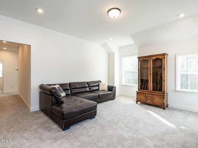 living area featuring baseboards, recessed lighting, and light colored carpet