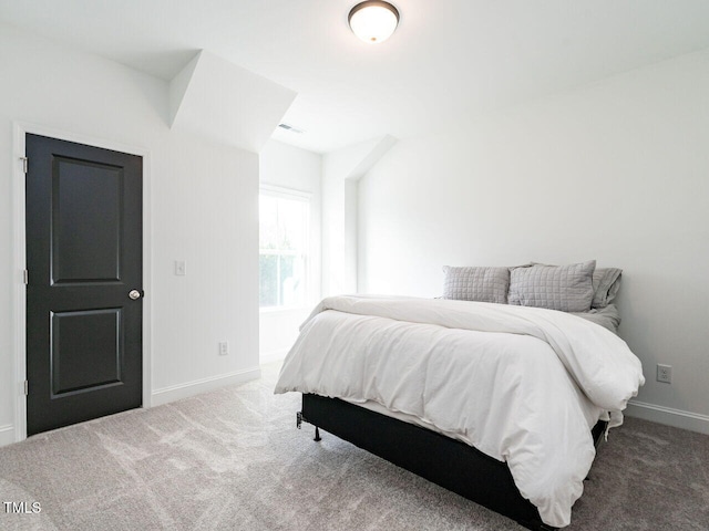 carpeted bedroom featuring visible vents and baseboards