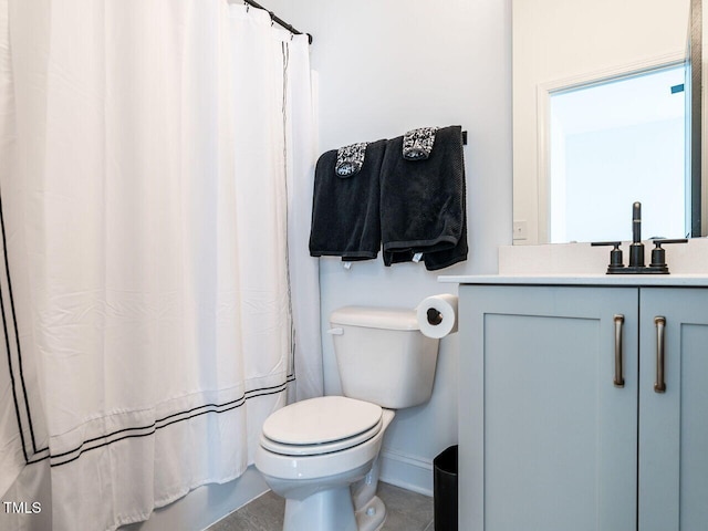 bathroom with shower / bath combo, baseboards, vanity, and toilet