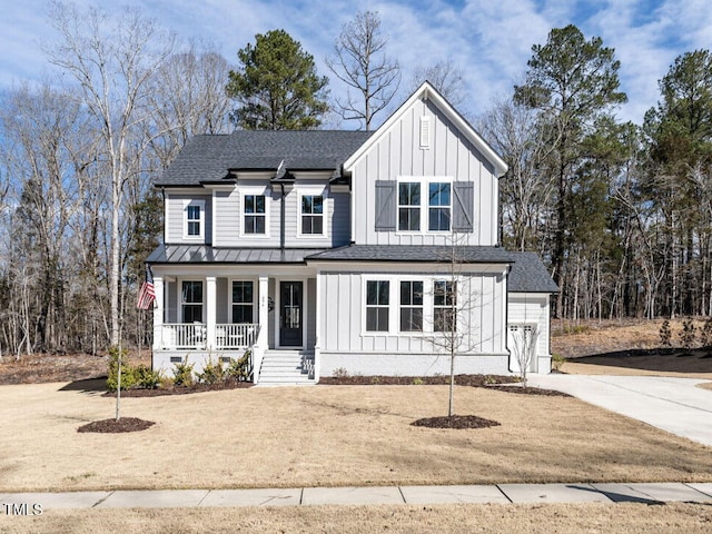 modern farmhouse featuring board and batten siding, roof with shingles, a porch, and driveway