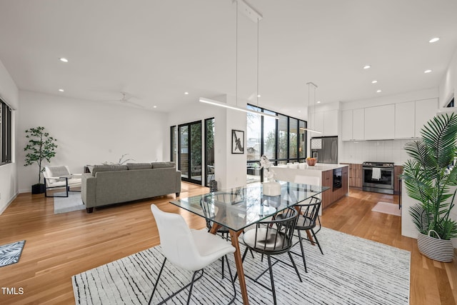 dining area featuring a ceiling fan, recessed lighting, and light wood finished floors