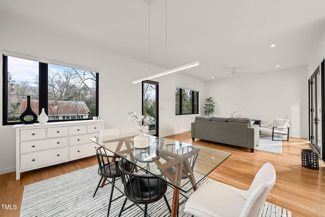 dining area with baseboards, light wood finished floors, a ceiling fan, and recessed lighting