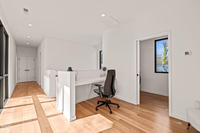 home office featuring baseboards, visible vents, light wood-style flooring, and recessed lighting