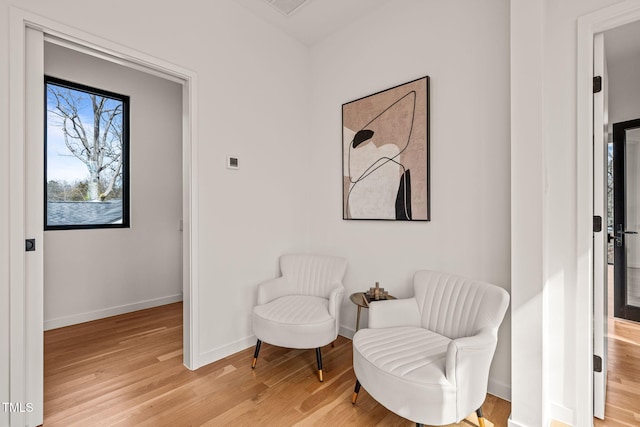 living area with light wood-style floors and baseboards