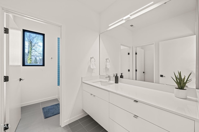 bathroom with tile patterned flooring, vanity, and baseboards