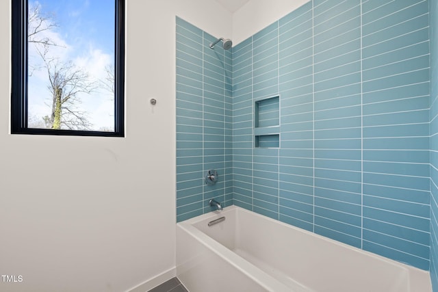 bathroom with shower / bath combination and baseboards