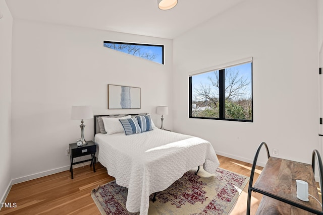 bedroom featuring light wood-style flooring and baseboards