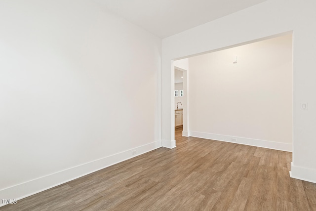 empty room featuring baseboards and wood finished floors