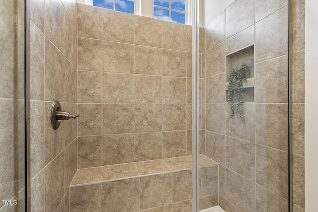 bathroom with tiled shower