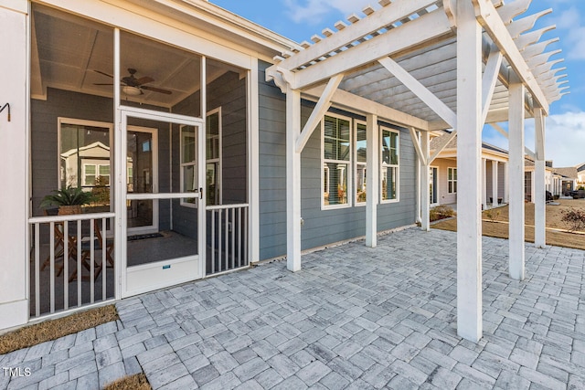 view of patio / terrace with a sunroom and a pergola