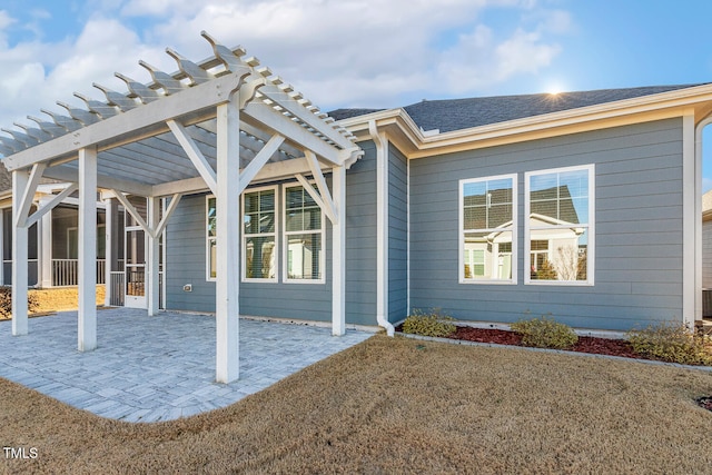 exterior space featuring a patio, roof with shingles, and a pergola