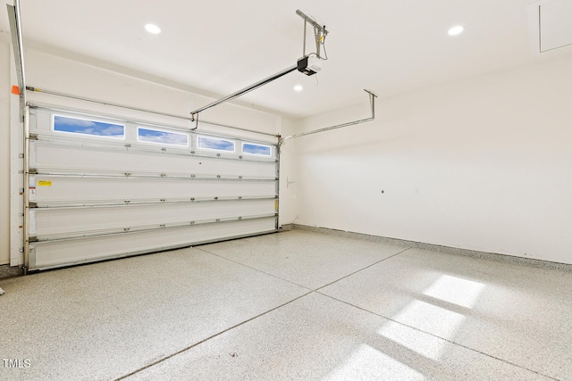 garage featuring a garage door opener, recessed lighting, and baseboards