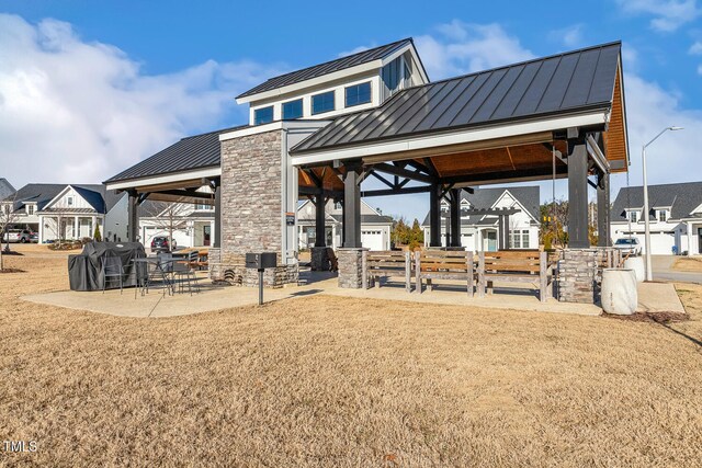 view of community featuring a patio and a lawn